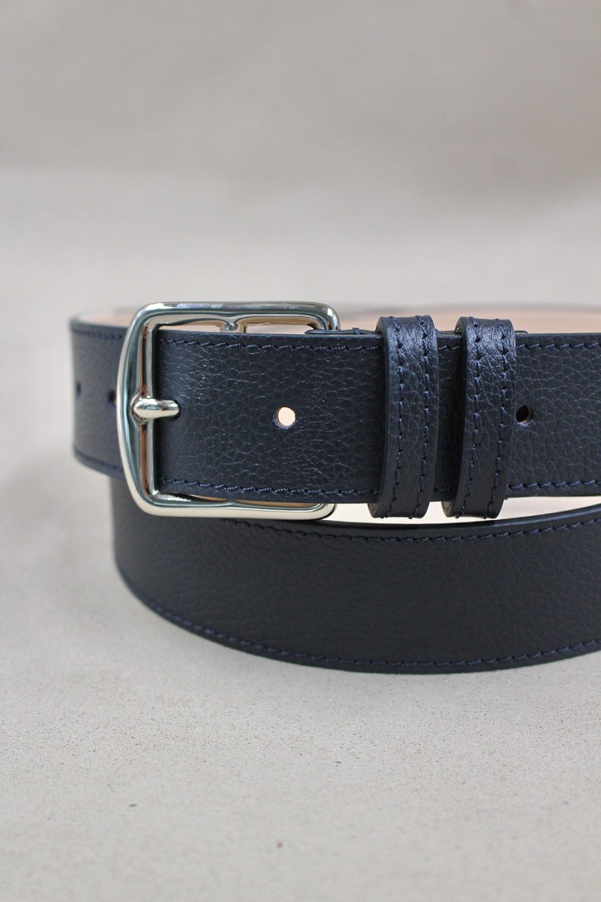 Ceinture cuir grainé bleu marine enroulée, boucle carrée argentée Étrivière